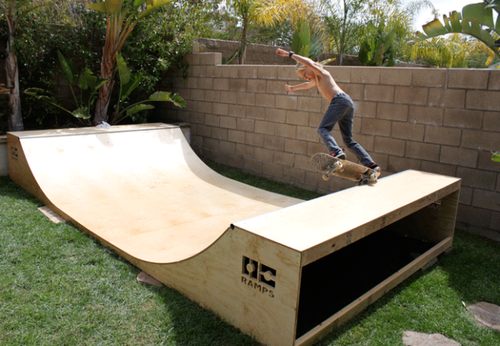 Skateboarding kid on Garage Mini Ramp by OC Ramps