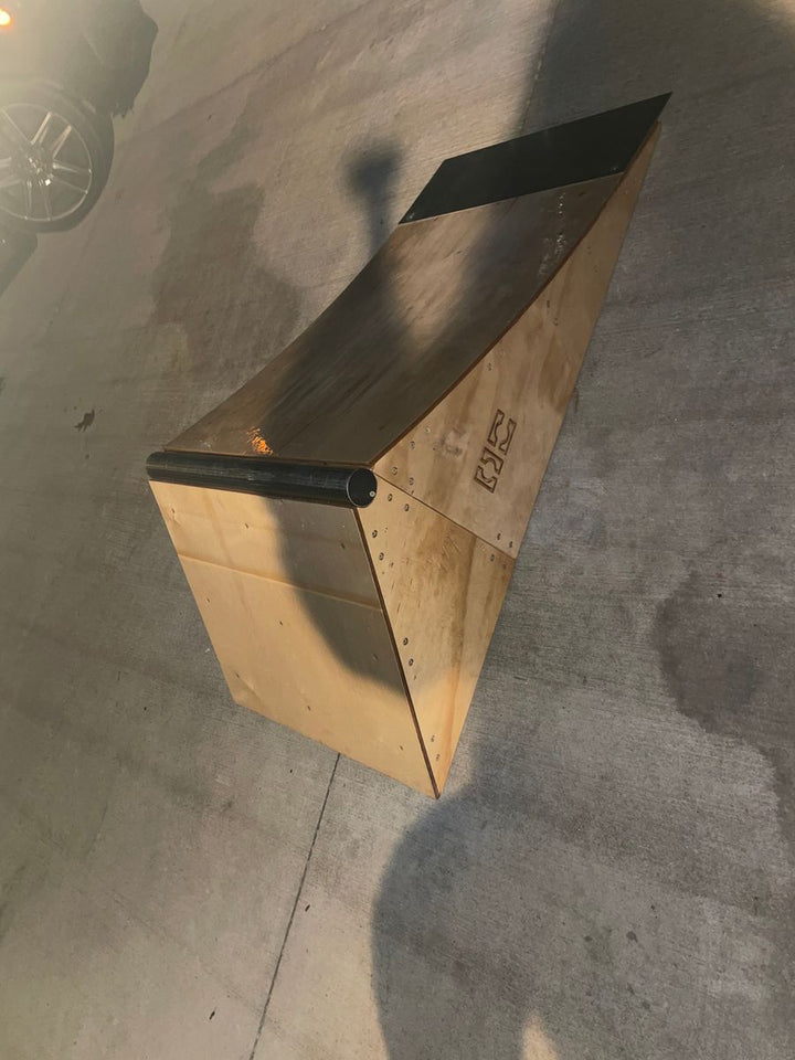 Customer photo of an OC Ramps wooden skate ledge showing its exposed plywood sides and metal coping