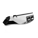 Angled view of the white OC Ramps fanny pack with black zipper and strap