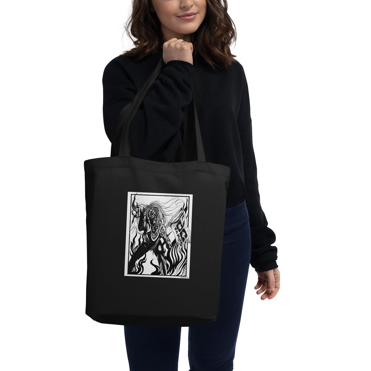 Person carrying the black Fulgore Demon tote bag over one shoulder