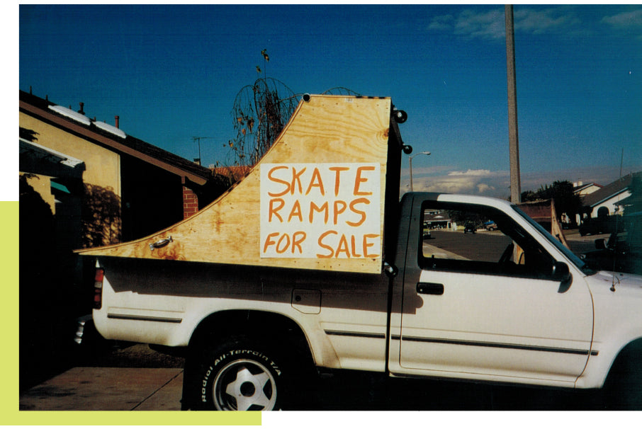An early wooden ramp with a hand-painted skate ramps for sale sign