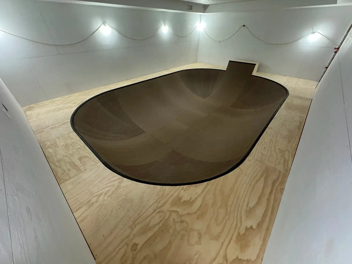 Completed indoor skate bowl with a dark brown coping in Laguna Beach, California.