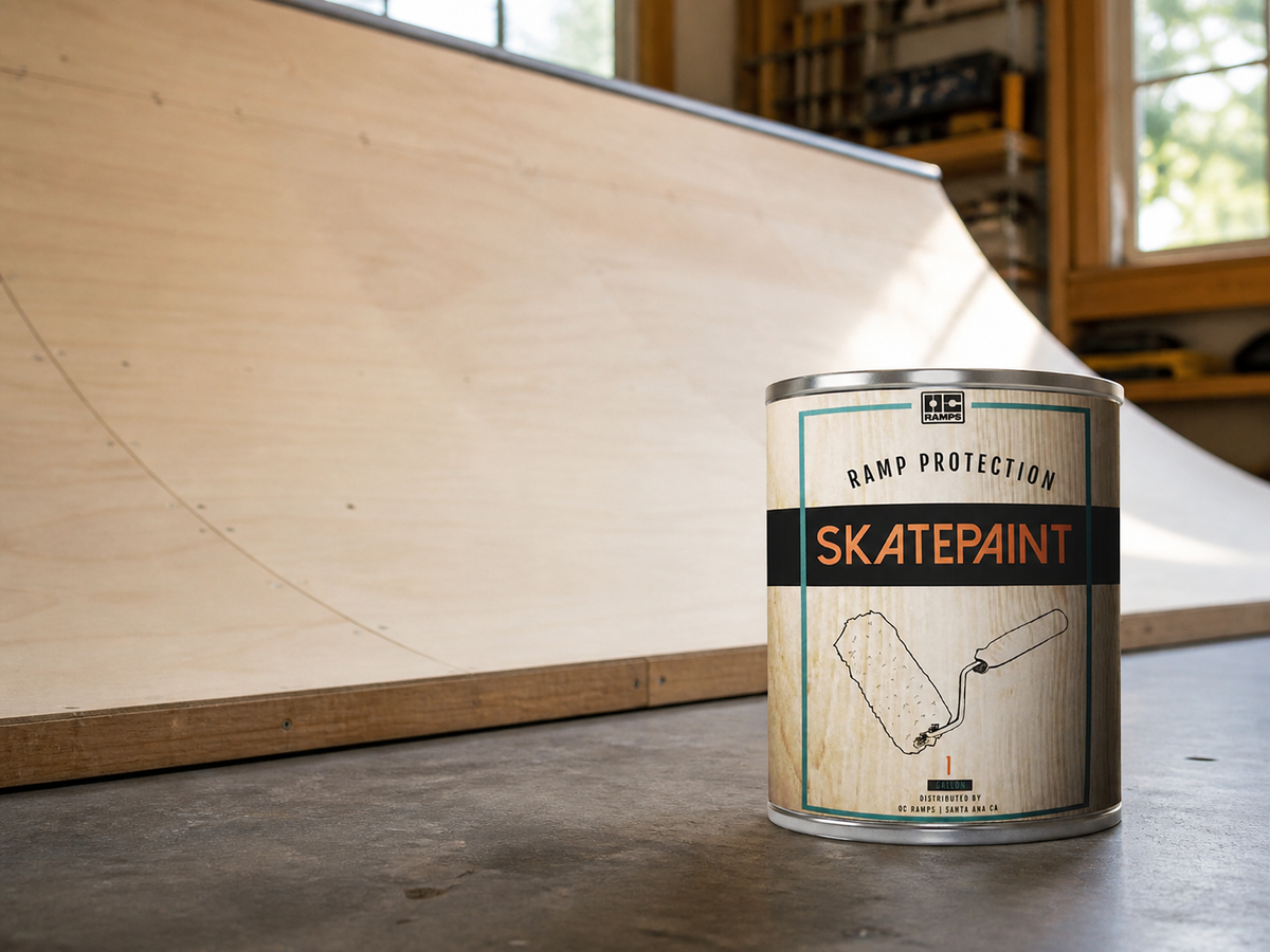 One gallon OC Ramps Skate Paint beside a wooden mini ramp