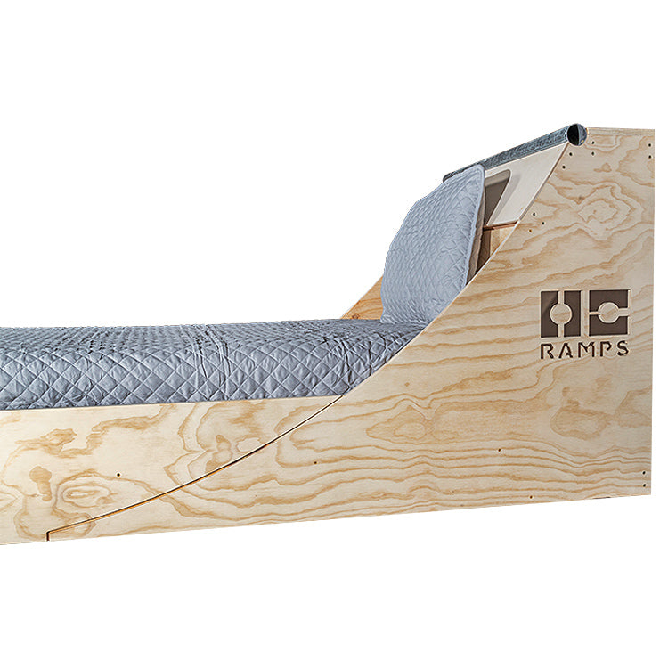 Side profile of the Quarter Pipe Bed showing the curved headboard and low footboard