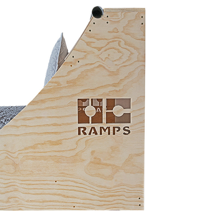 Close view of the Quarter Pipe Bed wooden side panel, curved headboard and OC Ramps logo