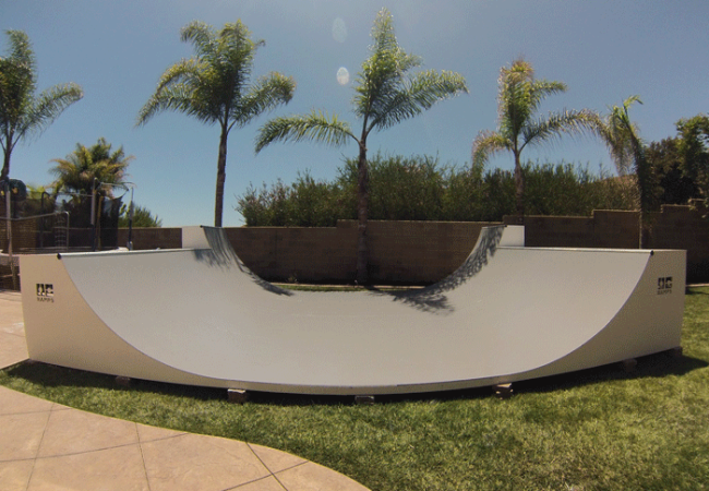 Front view of OC Ramps 16 foot wide half pipe with double extensions and topped with colored Skate Paint